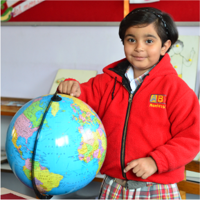 Montessori Student  standing with Globe